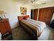 Bedroom features a ceiling fan, natural light, and wood closet doors at 8508 43Rd W Ave, Bradenton, FL 34209