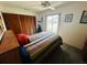 Bedroom features a ceiling fan, natural light, and wood closet doors at 8508 43Rd W Ave, Bradenton, FL 34209