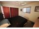 Bedroom features a ceiling fan, natural light, and wood closet doors at 8508 43Rd W Ave, Bradenton, FL 34209