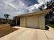 Attached garage with paneled-column detailing and a smooth driveway at 8508 43Rd W Ave, Bradenton, FL 34209