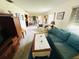 Cozy living room featuring an entertainment center, sofas, and a view into the dining area at 8508 43Rd W Ave, Bradenton, FL 34209