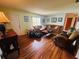 A comfortable living room featuring hardwood floors, a sofa, and abundant natural light at 8508 43Rd W Ave, Bradenton, FL 34209
