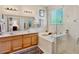 Luxurious bathroom boasts dual vanities, soaking tub, and a separate glass shower at 9052 41St E St, Parrish, FL 34219