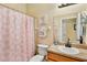 Charming bathroom with pink shower curtain, decorative towels, and vanity with a granite-look countertop at 9052 41St E St, Parrish, FL 34219
