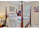 Comfortable bedroom with a four poster bed, shuttered window, and ample natural light at 9052 41St E St, Parrish, FL 34219