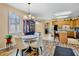 Open-concept dining area features stylish light fixture and views to the kitchen at 9052 41St E St, Parrish, FL 34219