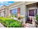 Inviting home featuring a screened front entrance, manicured shrubs, and accent shutters at 9052 41St E St, Parrish, FL 34219