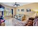 Relaxing living room with wood-look tile, comfortable seating, and natural light from the large window at 9052 41St E St, Parrish, FL 34219
