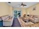 Spacious living room features wood-look tile floors and a sliding glass door at 9052 41St E St, Parrish, FL 34219