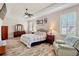 Relaxing main bedroom features wood-style floors, large windows, and tray ceiling at 9052 41St E St, Parrish, FL 34219