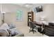 Comfortable home office featuring a modern desk, bookshelves, and cozy seating area for a productive workspace at 9052 41St E St, Parrish, FL 34219