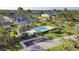 Aerial view showcasing the community pool, well-manicured lawns, and residential buildings, offering a resort-like lifestyle at 9560 High Gate Dr # 1622, Sarasota, FL 34238