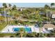 Overhead view featuring a community pool, golf course, and lush greenery, highlighting the community's amenities and landscape at 9560 High Gate Dr # 1622, Sarasota, FL 34238