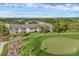 Scenic aerial view of a well-maintained condo building adjacent to a pristine golf course at 9560 High Gate Dr # 1622, Sarasota, FL 34238