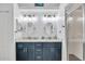 Bathroom with dual sinks, quartz countertops, framed mirrors, and a glass-enclosed shower at 9560 High Gate Dr # 1622, Sarasota, FL 34238