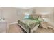 Bedroom featuring tropical-themed décor, neutral walls, and bedside table at 9560 High Gate Dr # 1622, Sarasota, FL 34238