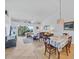Comfortable living room featuring tiled floors, cozy seating, and a sliding door leading to a balcony at 9560 High Gate Dr # 1622, Sarasota, FL 34238