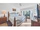 Comfortable main bedroom featuring a ceiling fan, a large window, and an en suite bathroom at 9560 High Gate Dr # 1622, Sarasota, FL 34238