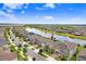 Beautiful aerial view of a two-story home with a pond in the backyard and lush landscaping at 9646 Ivory Dr, Ruskin, FL 33573