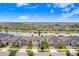 Aerial view of home with water view and manicured landscaping in a neighborhood setting at 9646 Ivory Dr, Ruskin, FL 33573