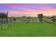 Expansive backyard with lush green grass and tranquil water view, perfect for outdoor activities at 9646 Ivory Dr, Ruskin, FL 33573