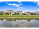 Scenic backyard view, backing onto tranquil water, with lush green grass at 9646 Ivory Dr, Ruskin, FL 33573