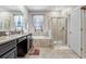 Bathroom showcasing a bathtub, glass door shower, stylish cabinets, and granite countertop at 9646 Ivory Dr, Ruskin, FL 33573