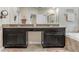 Elegant bathroom featuring double sinks, granite countertop, and a glass door shower at 9646 Ivory Dr, Ruskin, FL 33573