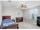 Cozy bedroom featuring a comfortable bed, ceiling fan, and natural light, offering a relaxing space at 9646 Ivory Dr, Ruskin, FL 33573