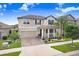 Charming two-story home featuring a manicured lawn, welcoming front porch and attached two-car garage at 9646 Ivory Dr, Ruskin, FL 33573