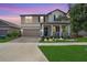 Charming two-story home with a well-manicured lawn and inviting front porch at 9646 Ivory Dr, Ruskin, FL 33573