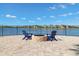 Community fire pit with seating overlooking the water, ideal for evening gatherings and relaxation at 9646 Ivory Dr, Ruskin, FL 33573
