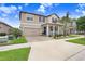 Charming two-story home with a manicured lawn and inviting front porch at 9646 Ivory Dr, Ruskin, FL 33573
