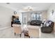 Cozy living room with comfortable seating, ceiling fan, TV, and sliding glass door to the backyard at 9646 Ivory Dr, Ruskin, FL 33573
