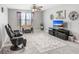 Spacious living room featuring a modern tv, fan, and decor, perfect for relaxation and entertainment at 9646 Ivory Dr, Ruskin, FL 33573