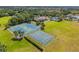 Aerial view of community amenities including tennis courts, and clubhouse with pool at 9840 50Th Street E Cir, Parrish, FL 34219