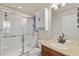 Bathroom featuring a glass-enclosed shower, white vanity, and ample lighting at 9840 50Th Street E Cir, Parrish, FL 34219