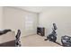 Bedroom featuring carpeted floors, a window with blinds, and exercise equipment at 9840 50Th Street E Cir, Parrish, FL 34219