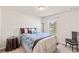 Bedroom featuring a cozy bed, side table, and neutral colored walls at 9840 50Th Street E Cir, Parrish, FL 34219