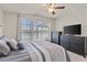 Bright bedroom with large window, TV, and modern furniture at 9840 50Th Street E Cir, Parrish, FL 34219