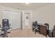 Bright bedroom with carpet, closet, desk, and exercise equipment at 9840 50Th Street E Cir, Parrish, FL 34219