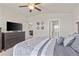 Bedroom showing closet doors, an ensuite bathroom and TV at 9840 50Th Street E Cir, Parrish, FL 34219