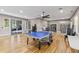 Game room features a ping pong table, stylish lighting, and a wood floor at 9840 50Th Street E Cir, Parrish, FL 34219