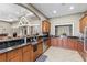Well-equipped kitchen with sleek black countertops, wooden cabinets, and stainless steel appliances at 9840 50Th Street E Cir, Parrish, FL 34219