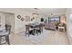 Open-concept living room with dining area featuring tile floors and a comfortable seating arrangement at 9840 50Th Street E Cir, Parrish, FL 34219