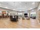 Expansive lounge featuring a central dining table, cozy armchairs, and a modern entertainment system at 9840 50Th Street E Cir, Parrish, FL 34219