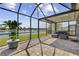 Screened patio with brick flooring offers seating and a serene view of the lake at 9840 50Th Street E Cir, Parrish, FL 34219