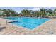 Community swimming pool with clear blue water and brick paver deck at 9840 50Th Street E Cir, Parrish, FL 34219