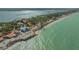 Wide aerial of beachfront property on a coastline with waves crashing in at 1042 N Casey Key Rd, Osprey, FL 34229