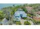 Expansive aerial view of the meticulously maintained property with a screened-in pool and lush tropical landscaping at 1042 N Casey Key Rd, Osprey, FL 34229